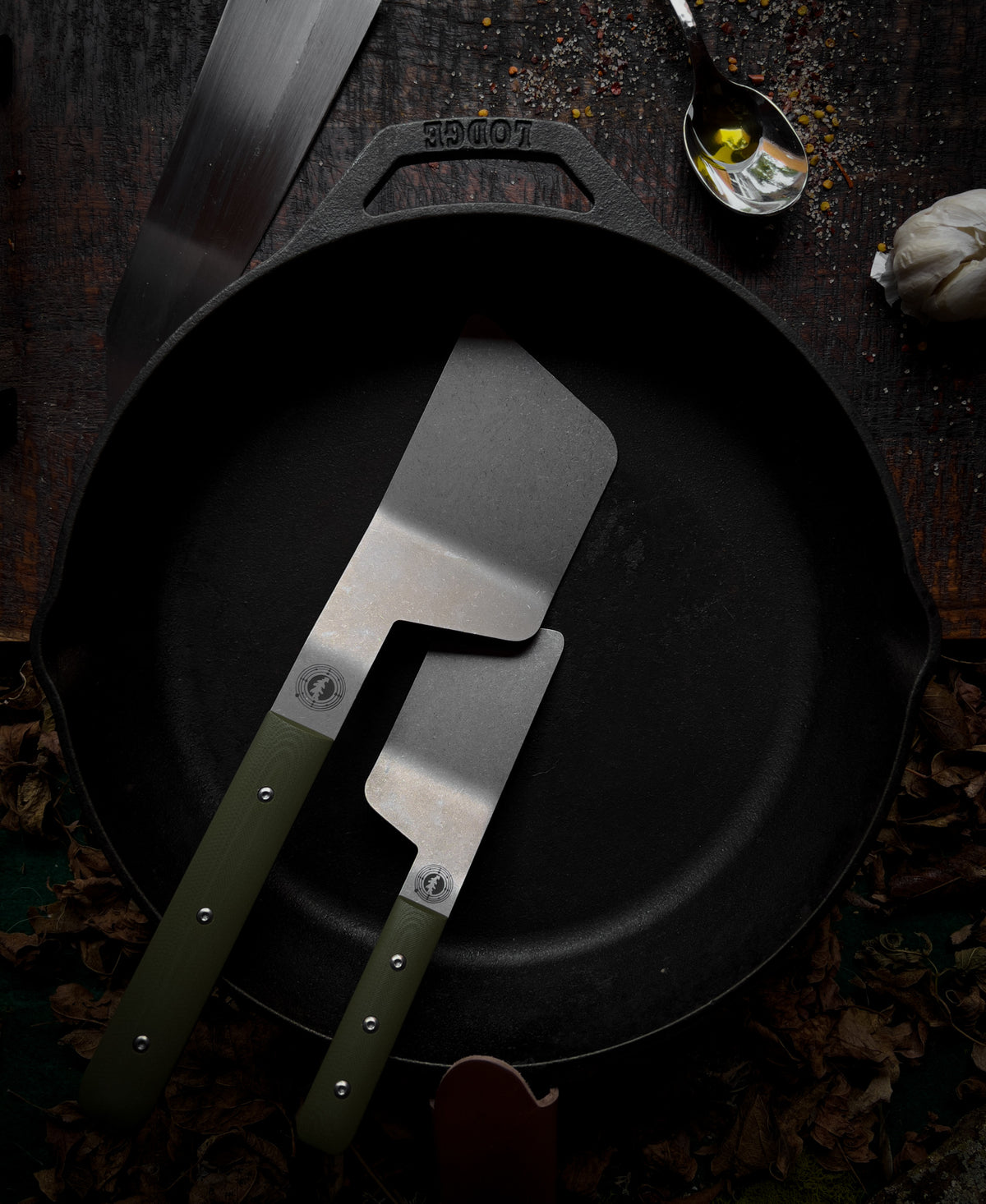 a left handed full and mini size spatula sitting in a skillet
