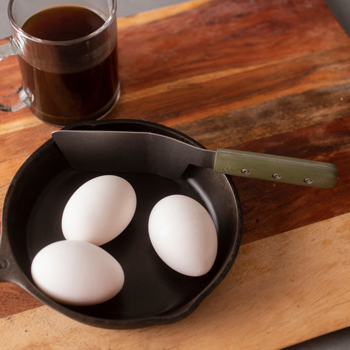 a mini spatula sitting with 3 eggs