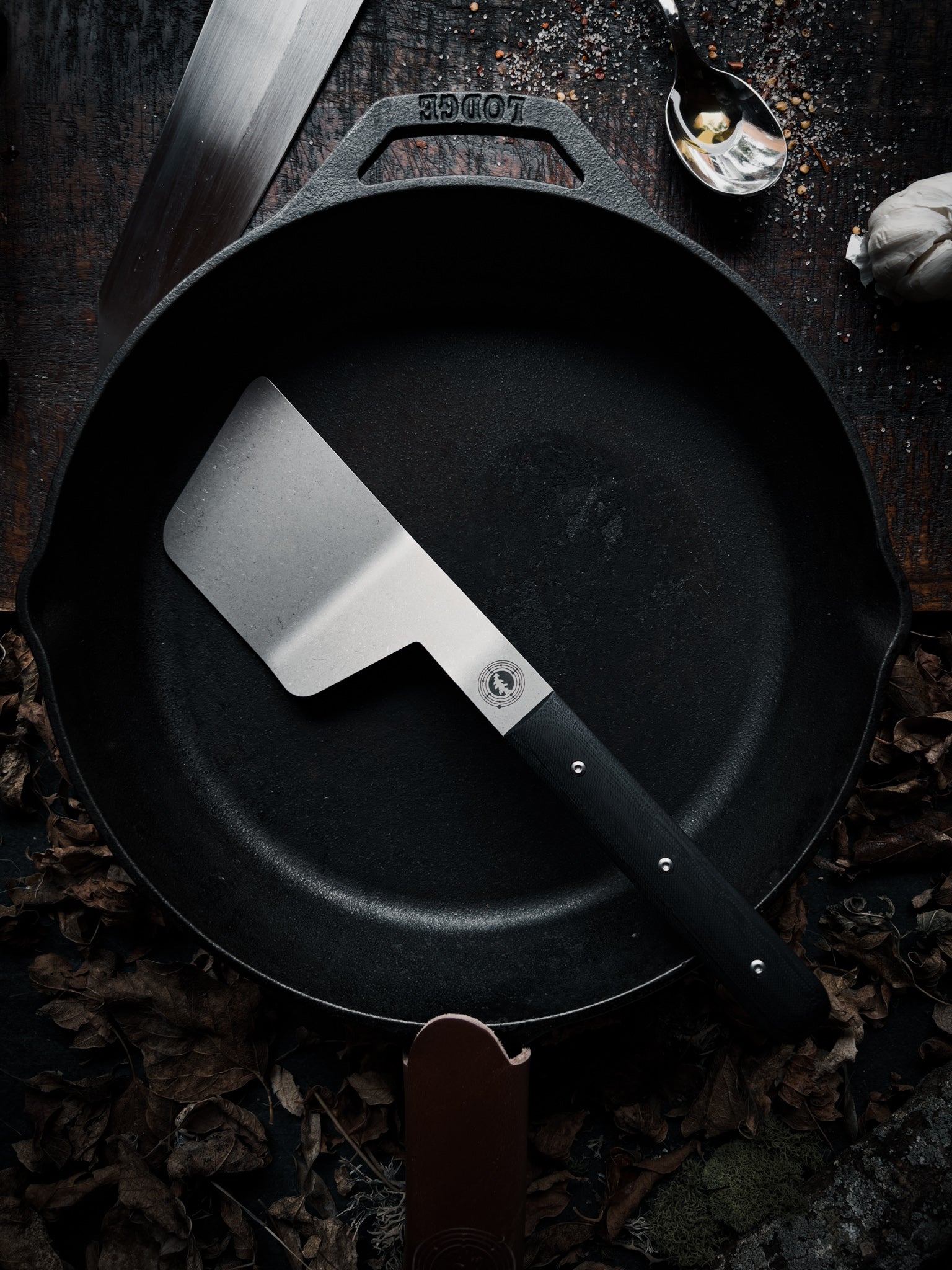 Full size spatula sitting on cast iron pan